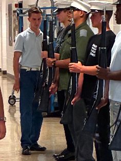 MCJROTC cadets practicing with drill rifles